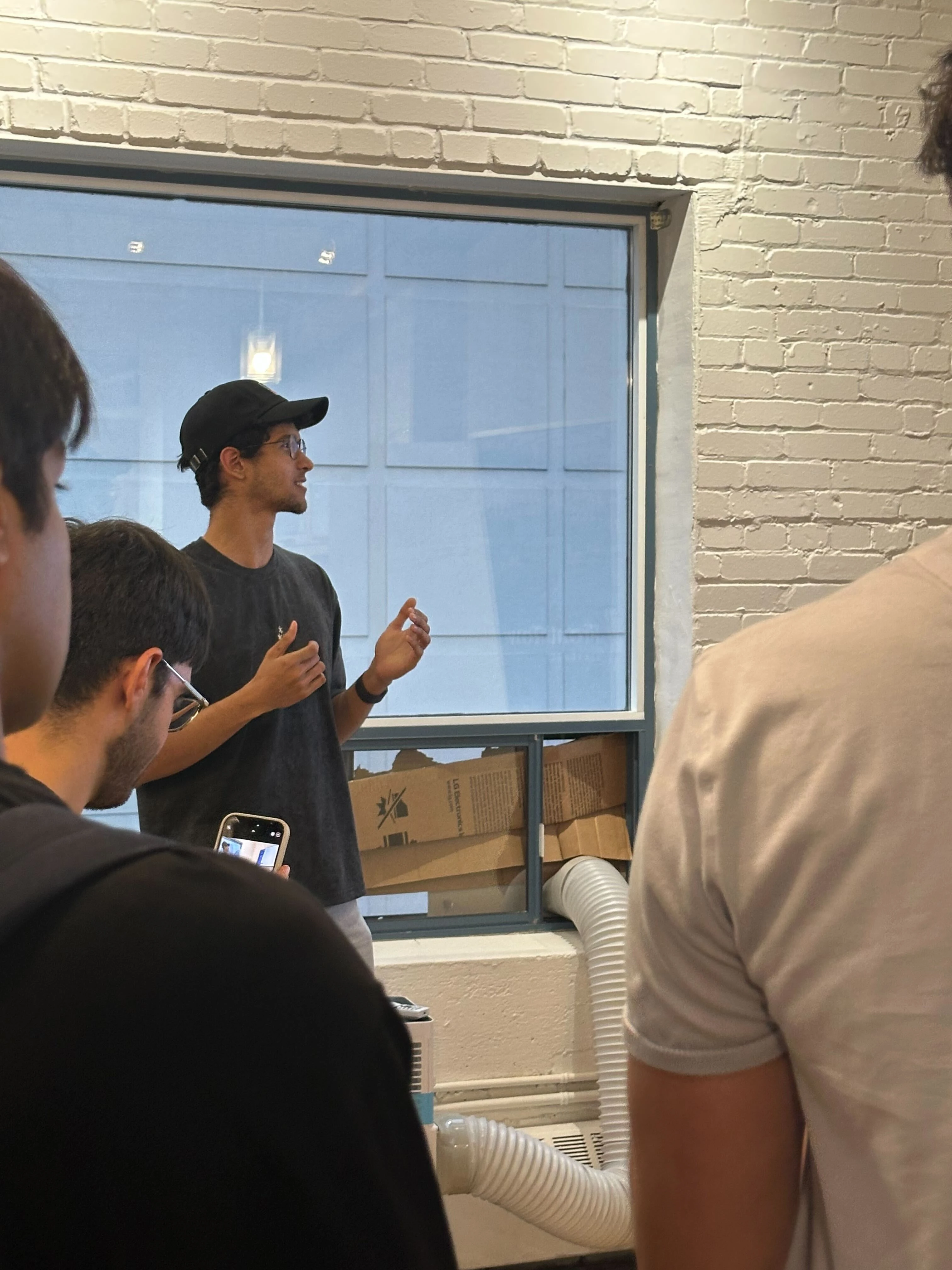 A student shares an idea with a group at a student founder coworking night